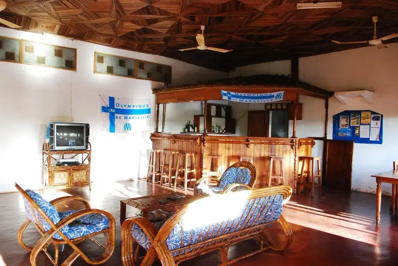 Salon et bar en bois, fauteuils bleus et blancs